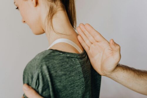 A professional chiropractor assisting a patient with spine alignment therapy.